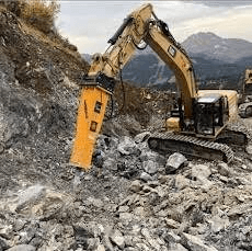 CAT excavator with hydraulic breaker attachment working a quarry