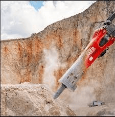 Hydraulic breaker in action in quarry