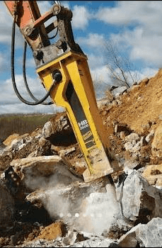 Hydraulic breaker in action breaking rock